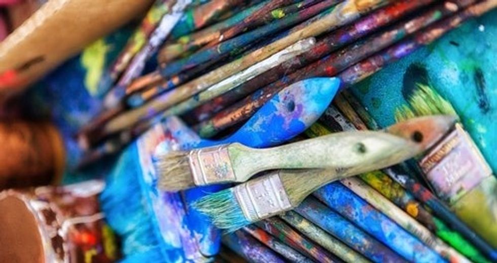 Paint brushes stacked on top of each other