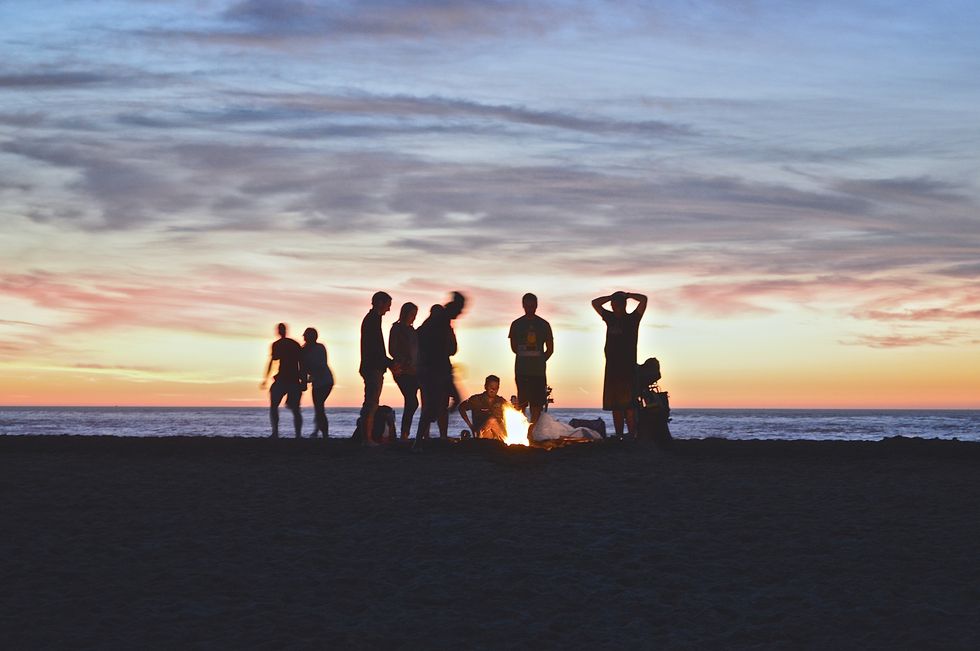 people partying at beach bonfire party