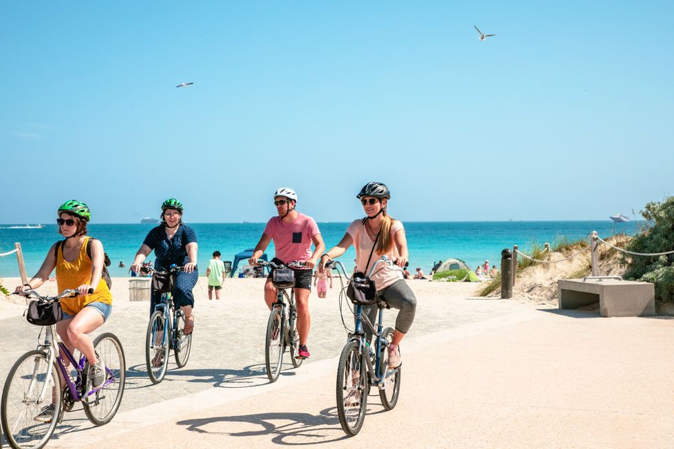 People riding bikes on the beach