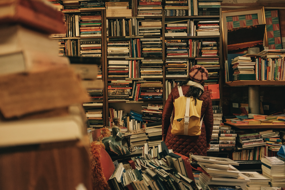 person carrying backpack inside library