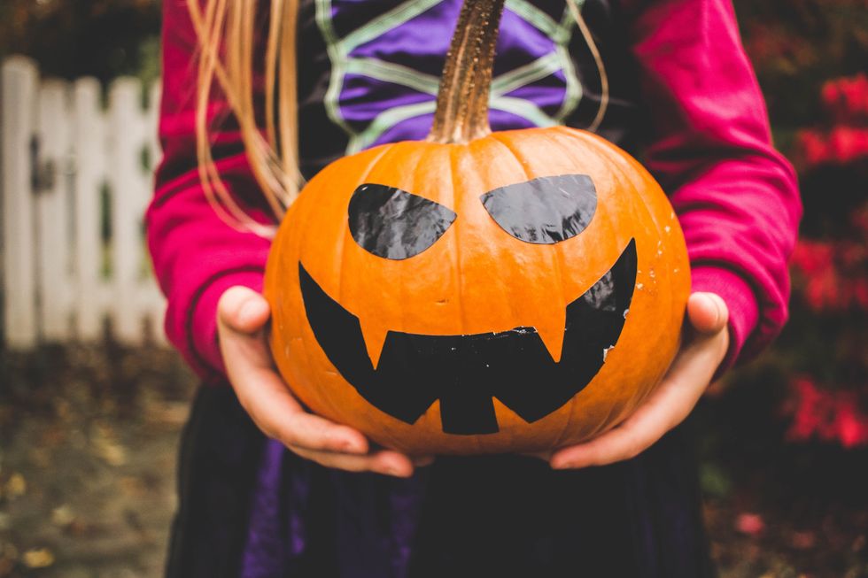 person holding jack-o-lantern