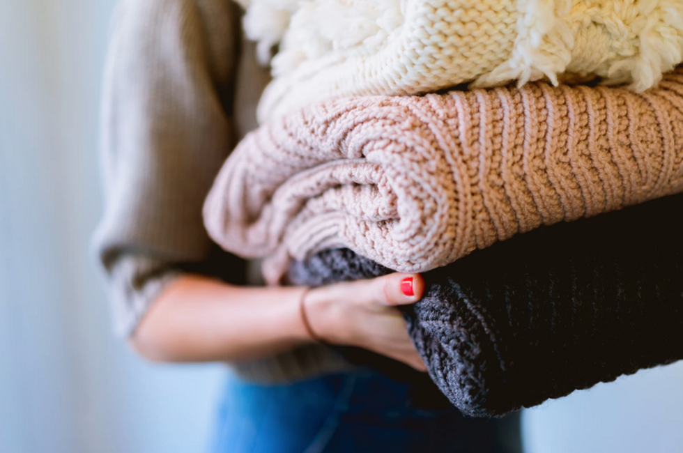 person holding knitted textiles
