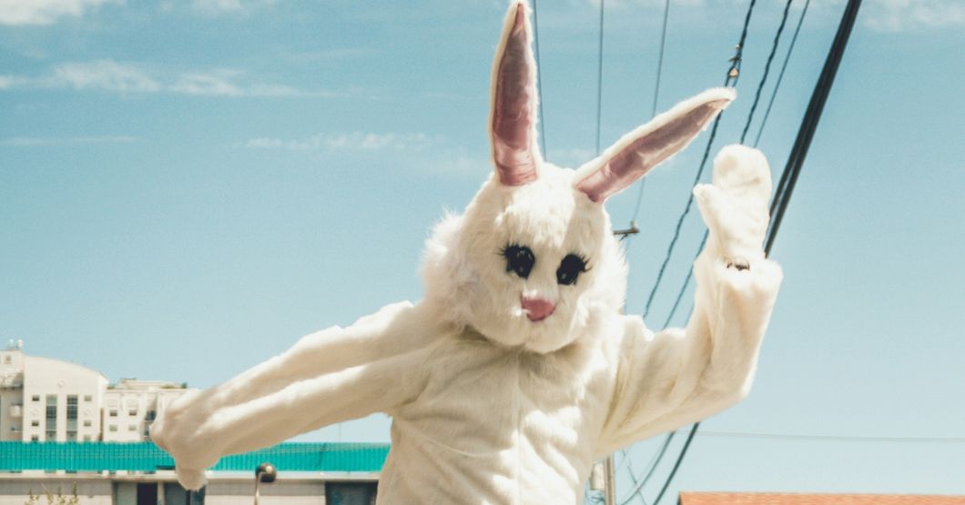 Person in a bunny suite mid air jumping 