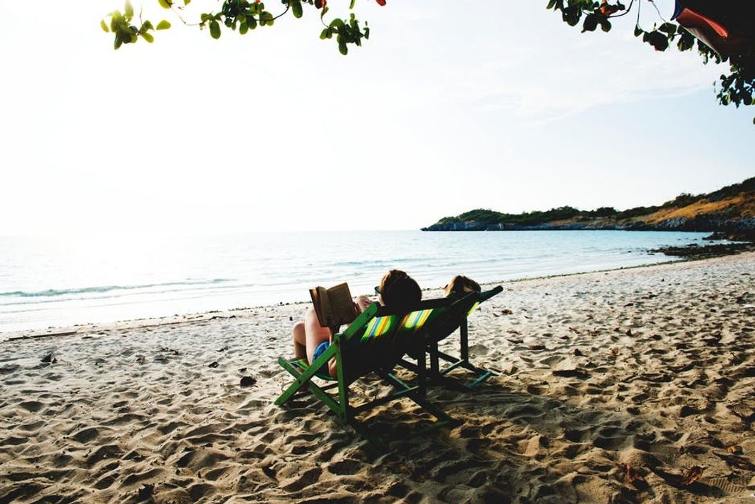 Person Reading On The Beach During The Summer