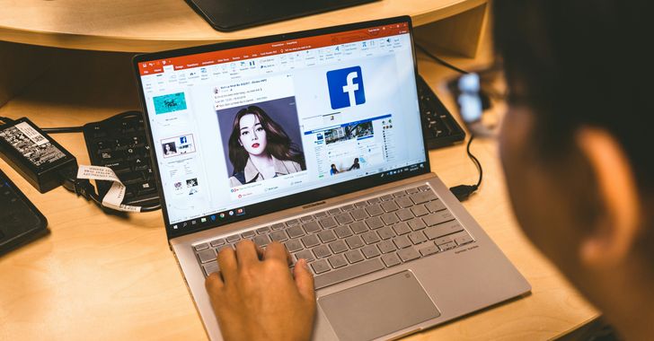 person using laptop browsing facebook application