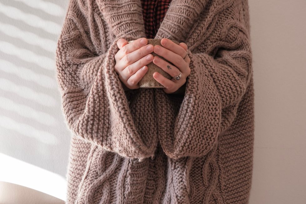 Person wearing a brown sweater.