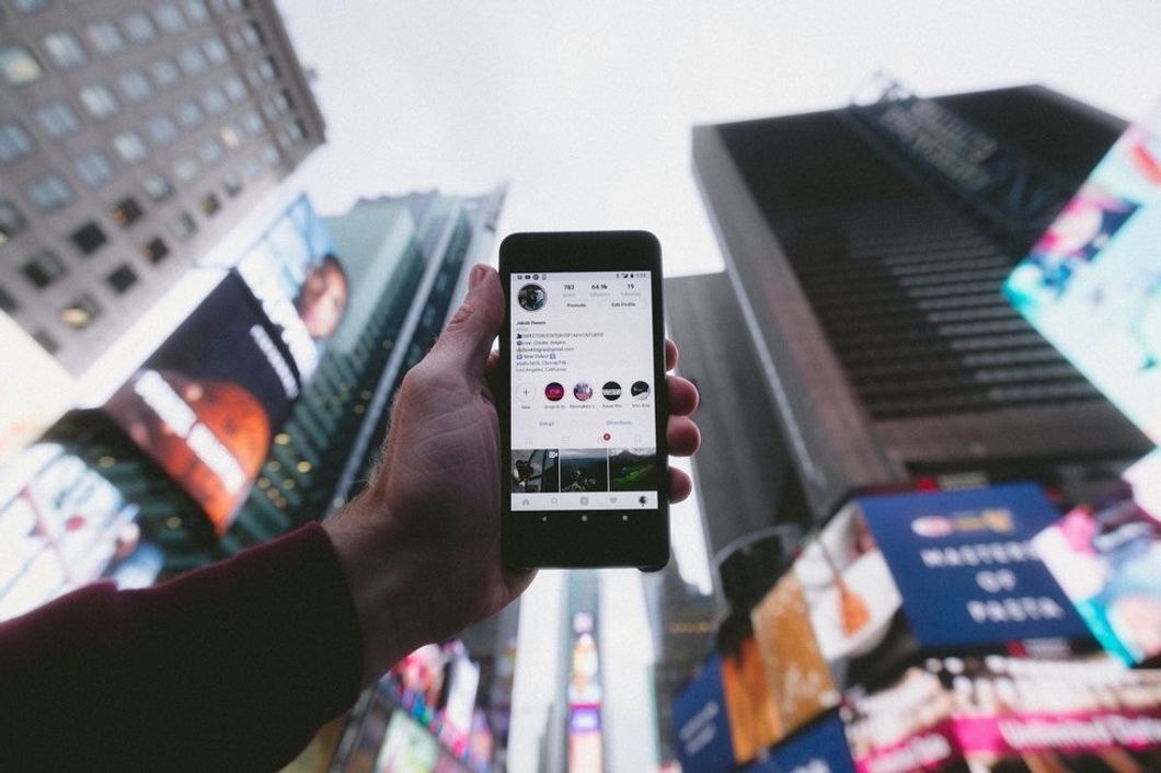 Phone with Instagram open, held up, in New York