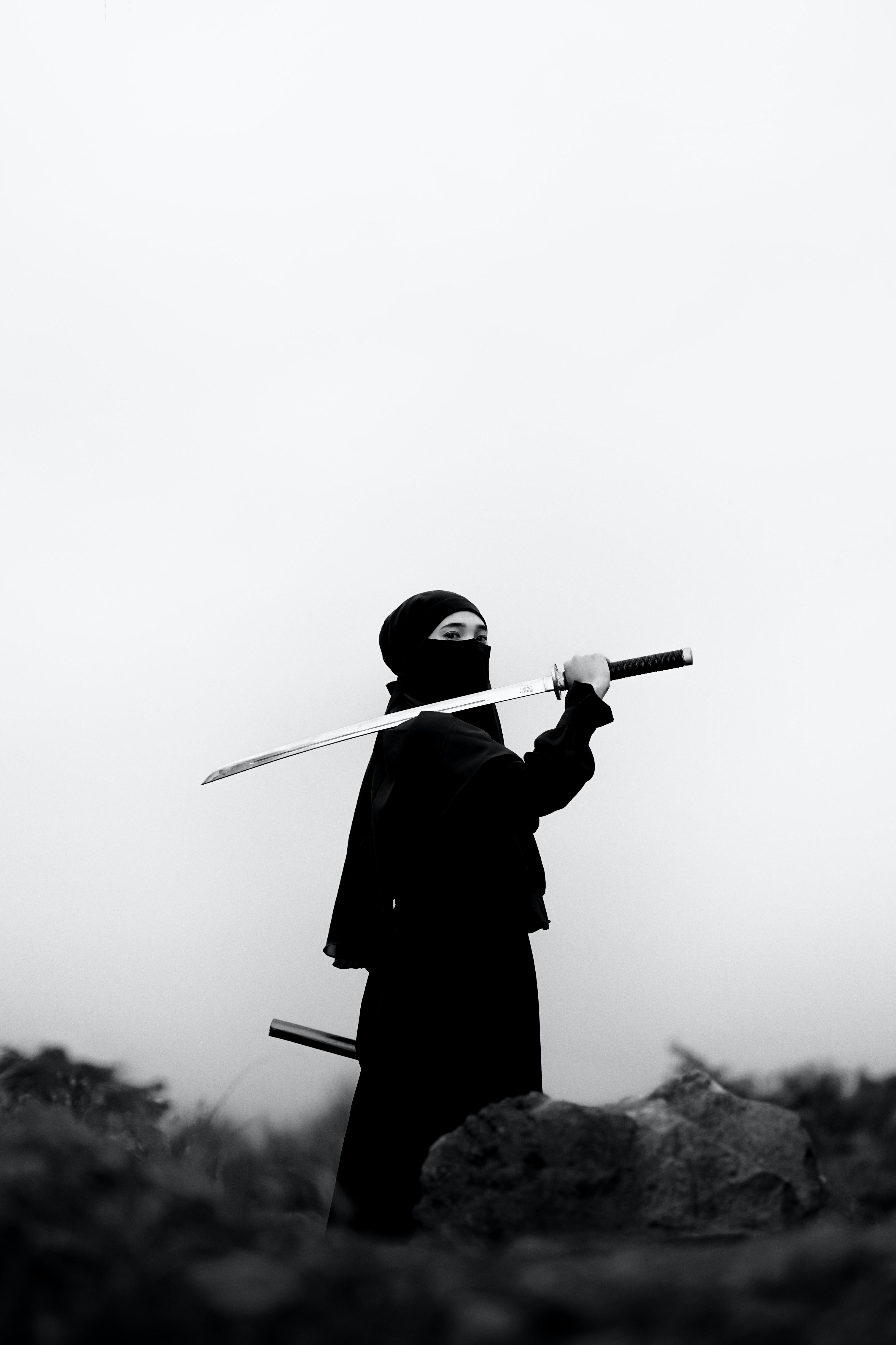 Photo by Azis Js: https://www.pexels.com/photo/samurai-standing-with-katana-12461376/