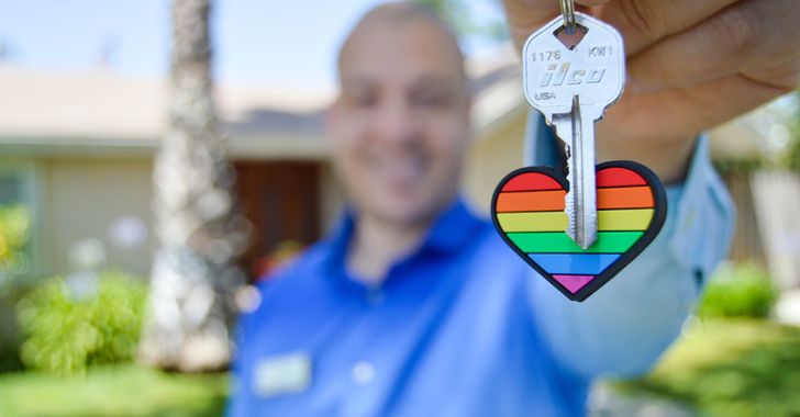 photo of gray key with rainbow heart key chain