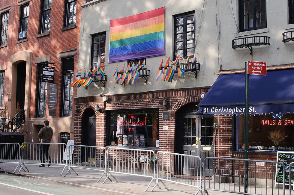 (pictured: Stonewall inn with pride flags)