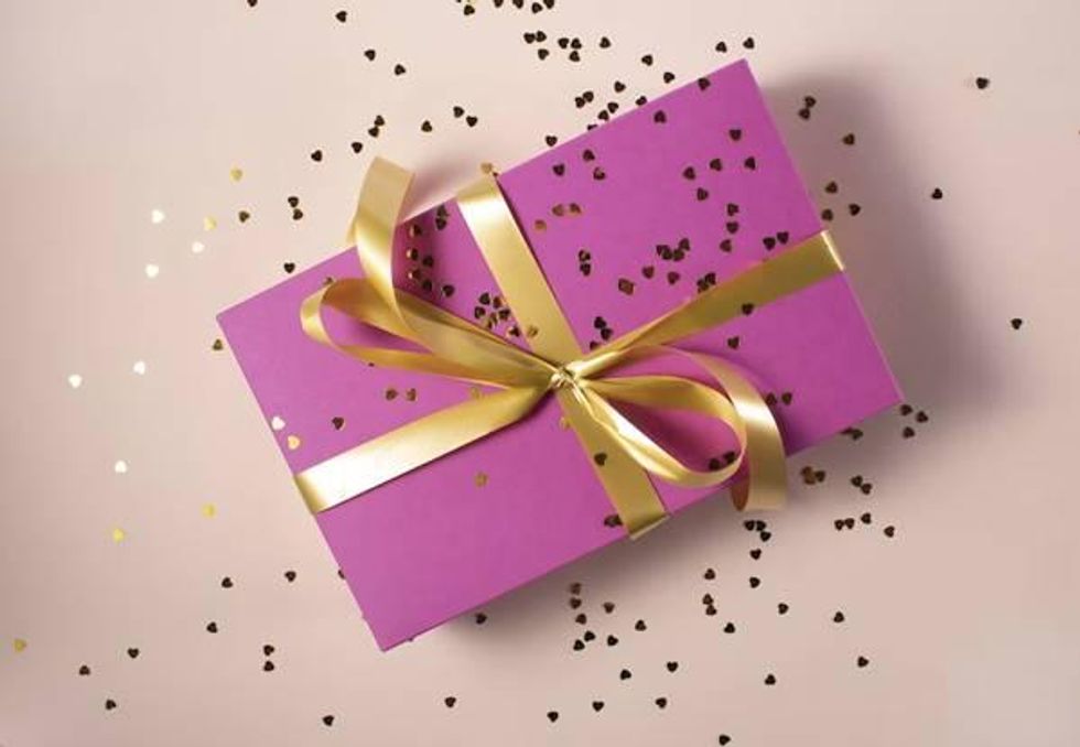 pink gift wrapped with a golden bow