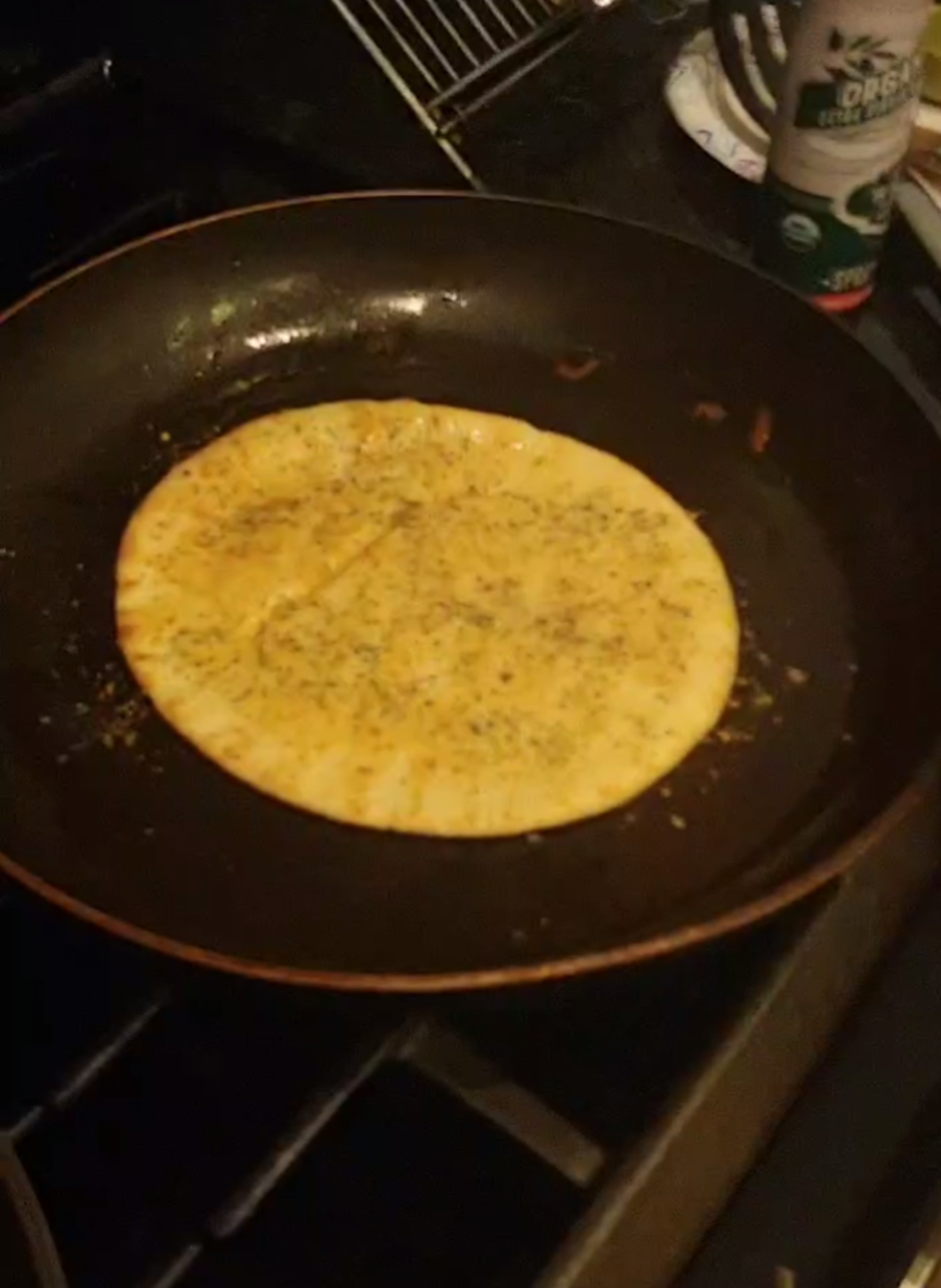 Pita bread cooking on stove