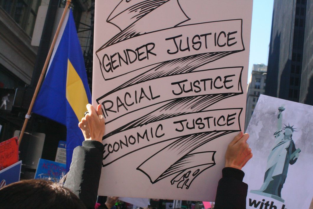 protester holding equality sign during march