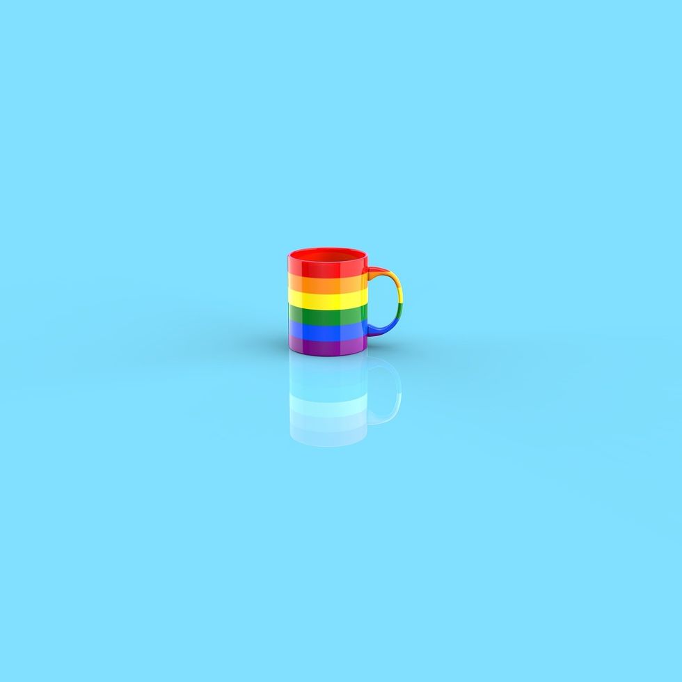 Rainbow coffee cup with light blue background