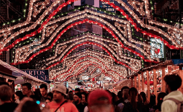 red, white, and green lights above a crowd of people