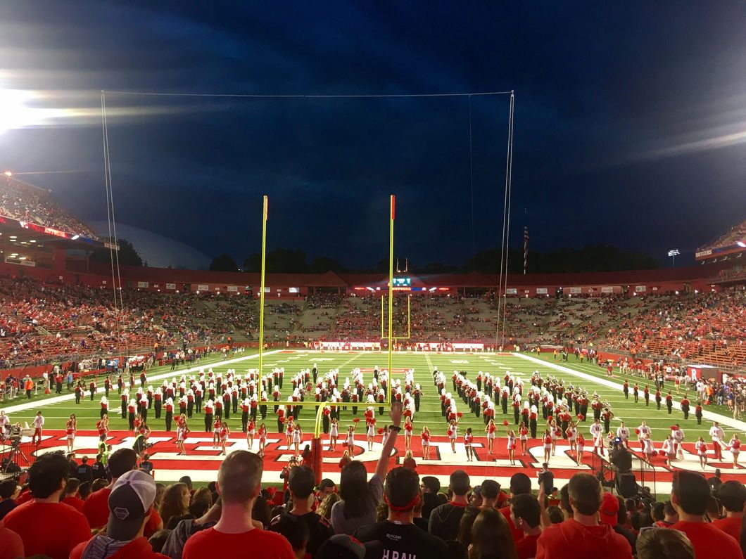 Rutgers students and marching band at a football game