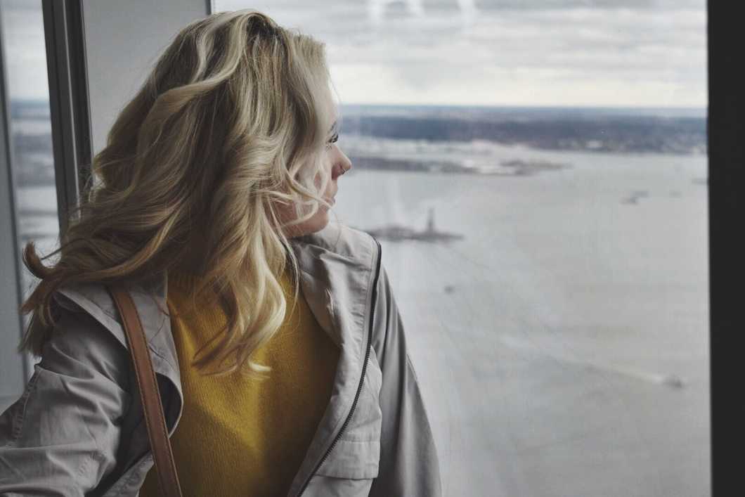 sad girl with mental health condition looking out window
