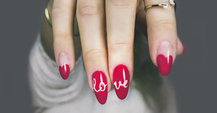 Selective focus photography of woman's red manicure