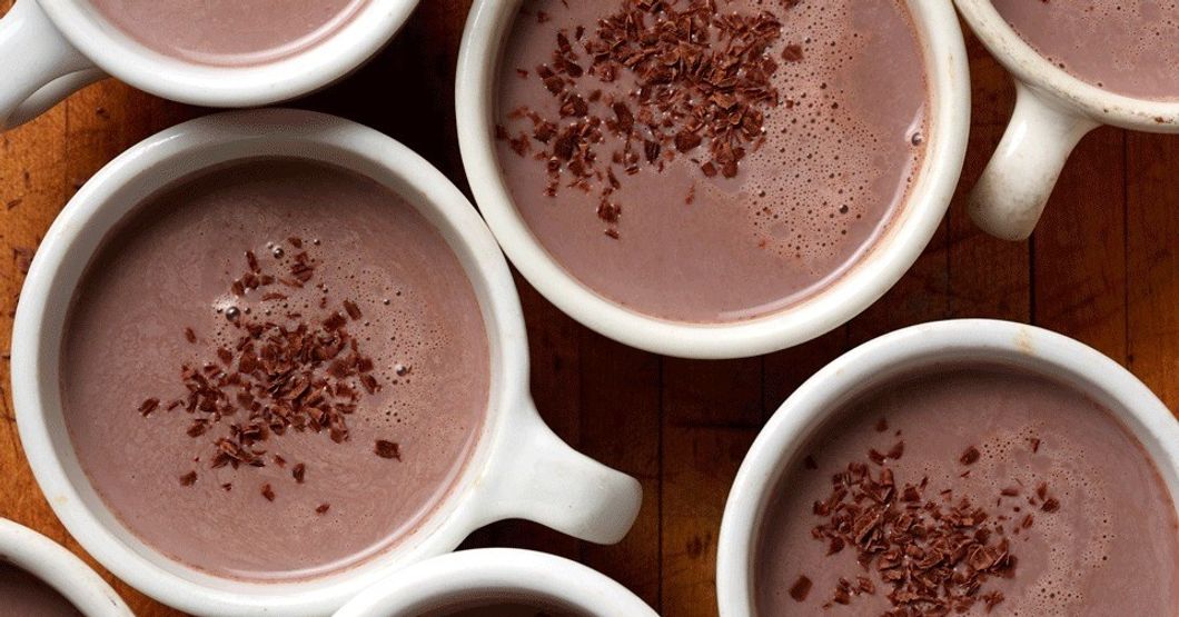 seven cups of hot chocolate on a wodden table