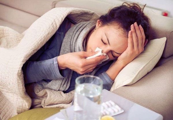Sick college student lying on couch