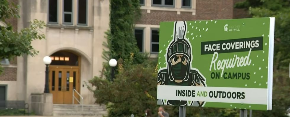 Sign stating the face mask requirement at Michigan State University. 