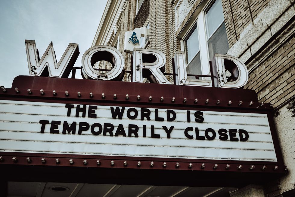 sign that says "The world is temporarily closed"