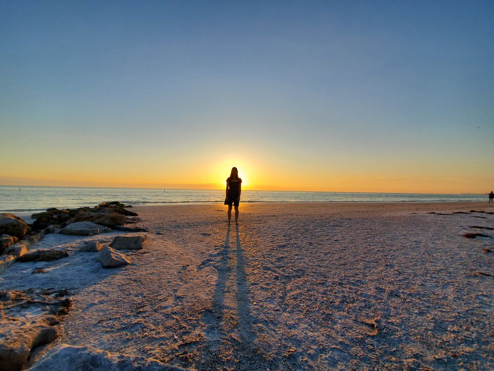 Silhouette in front of beach sunset