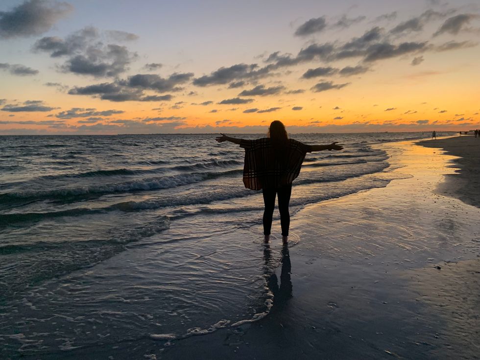 silhouette of girl at sunset on beach