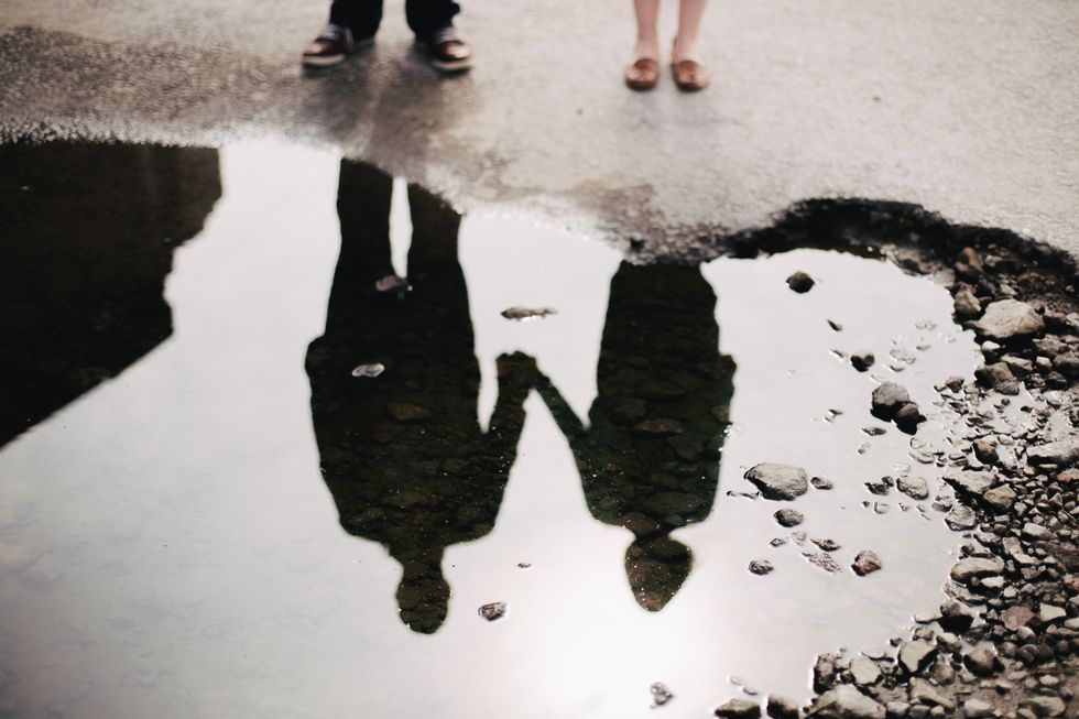 silhouettes in a puddle