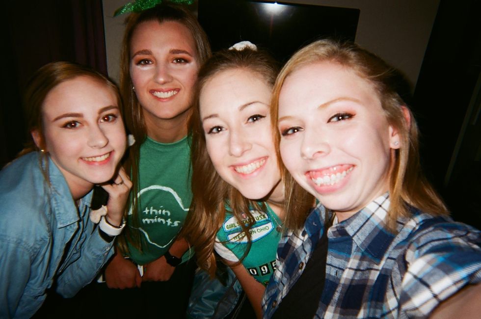 smiling college student friends taking selfie at party