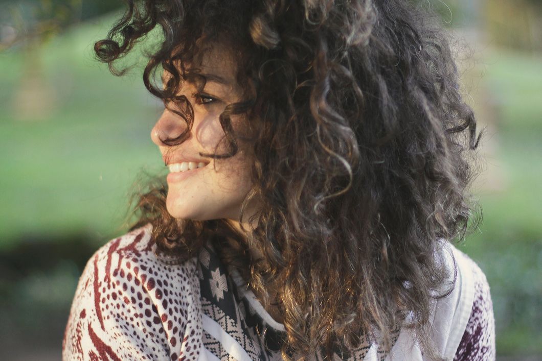 smiling curly haired woman