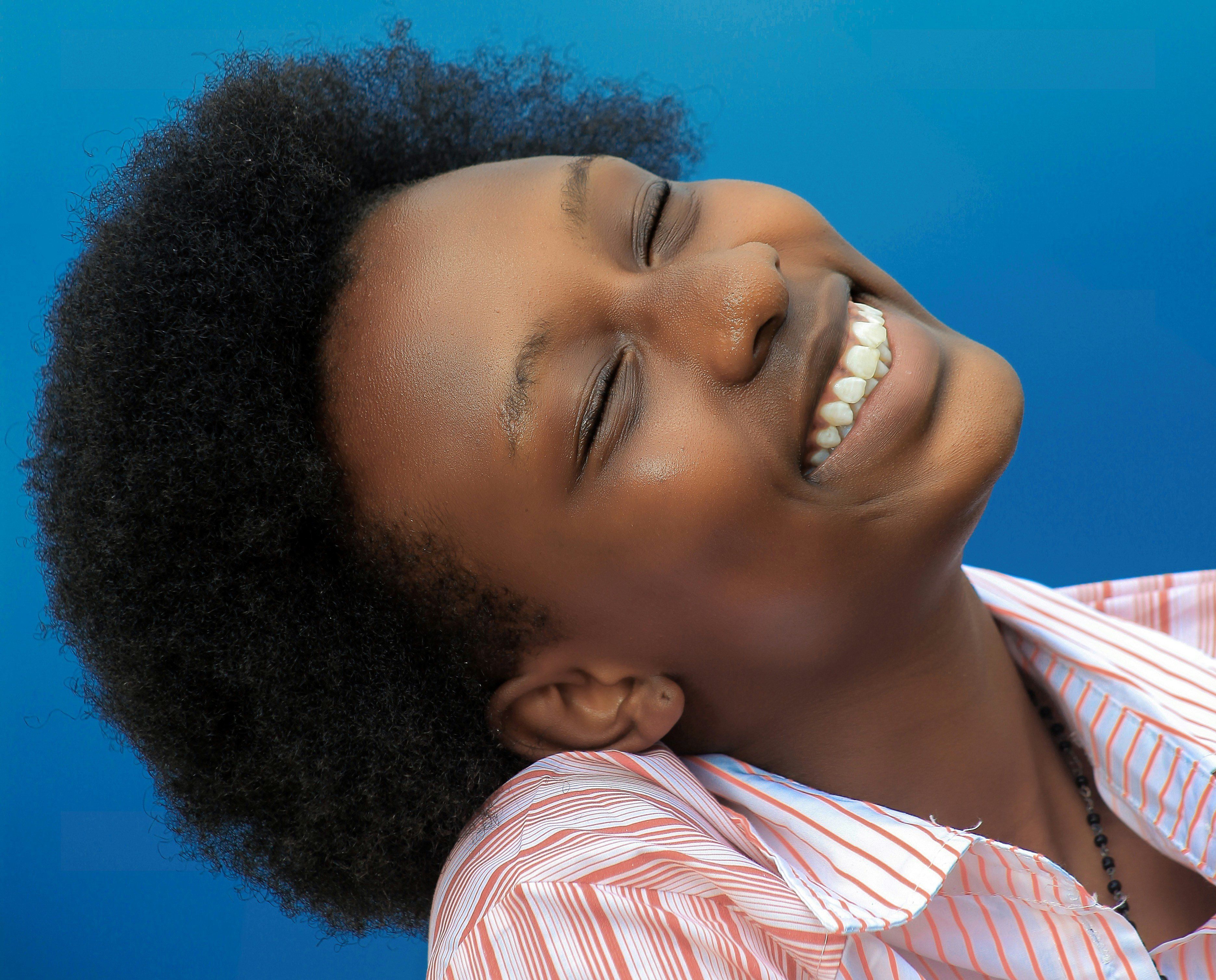 smiling girl in pink and white stripe shirt