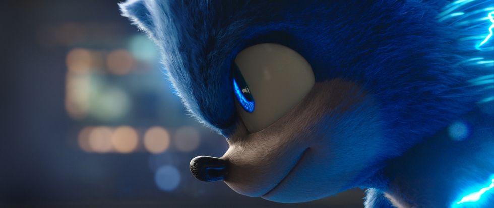 Sonic, a blue cartoon hedgehog that produces electricity and runs fast, look up from a runner's stance. The photo is a close up of his face in a scene from "Sonic The Hedgehog," in theaters on February 14, 2020.