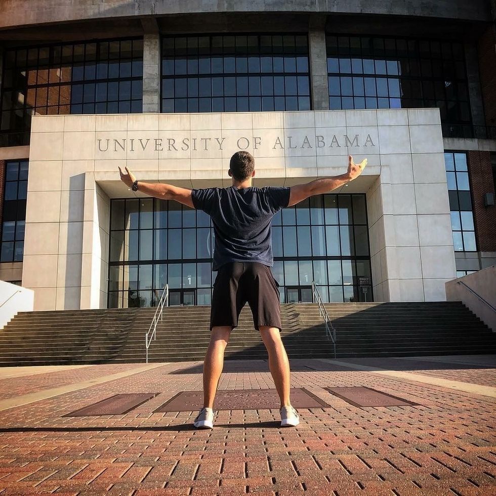 student standing in front of Bryant-Denny stadium in Alabama