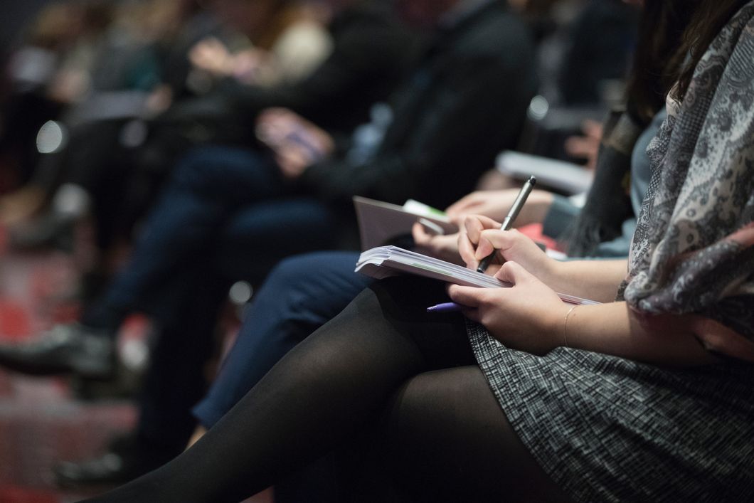 Students taking notes at a lecture