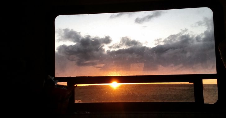 Sunset through an RV window in the dark