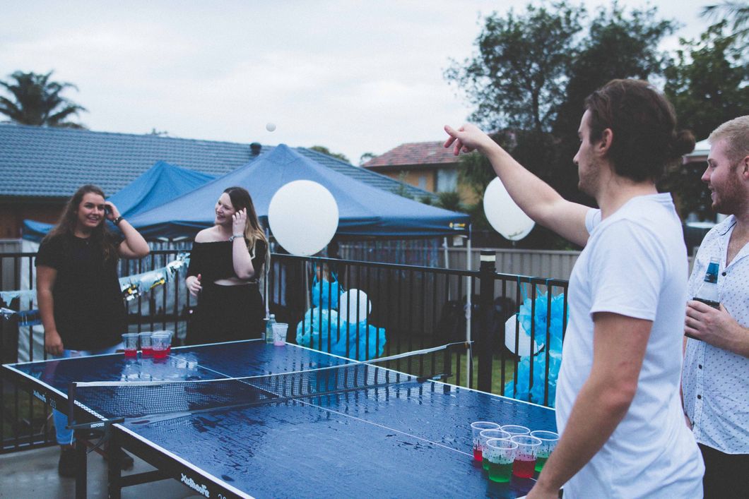 Teens playing juice pong