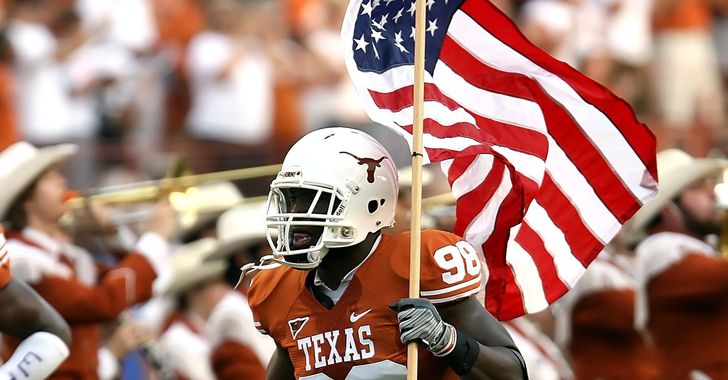 Texas Longhorn football player runs with American flag
