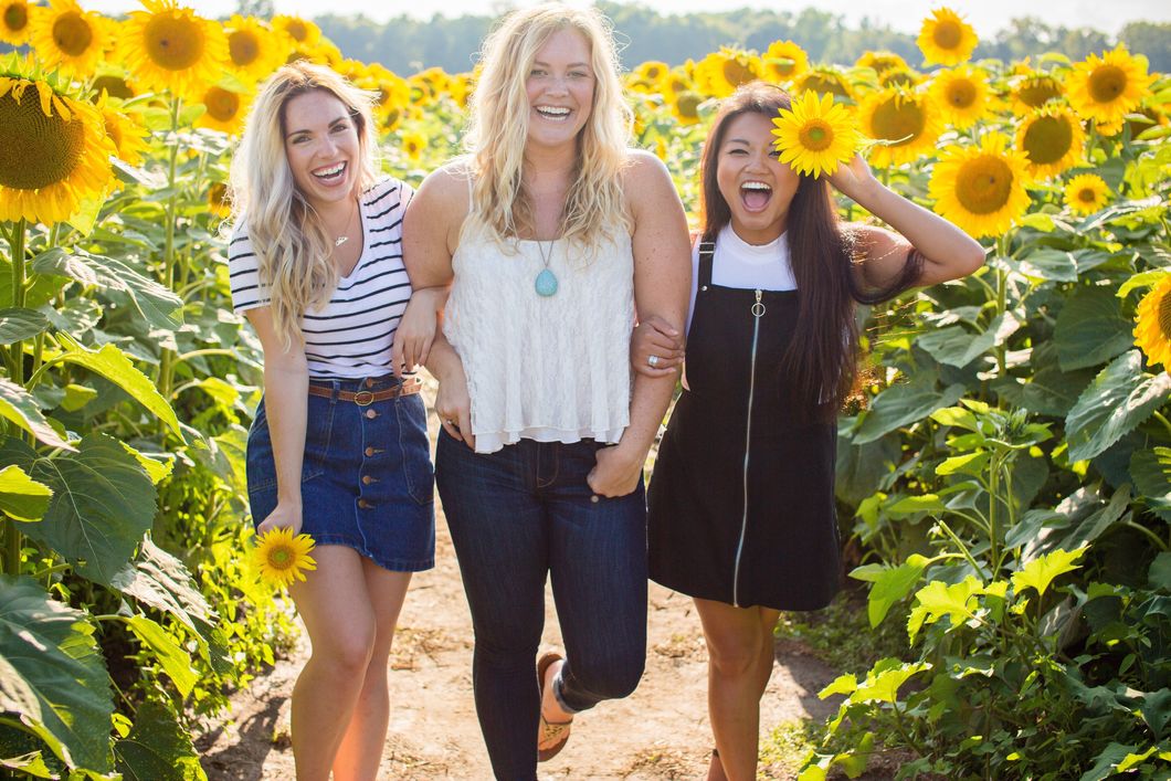Three girls in sunflower field