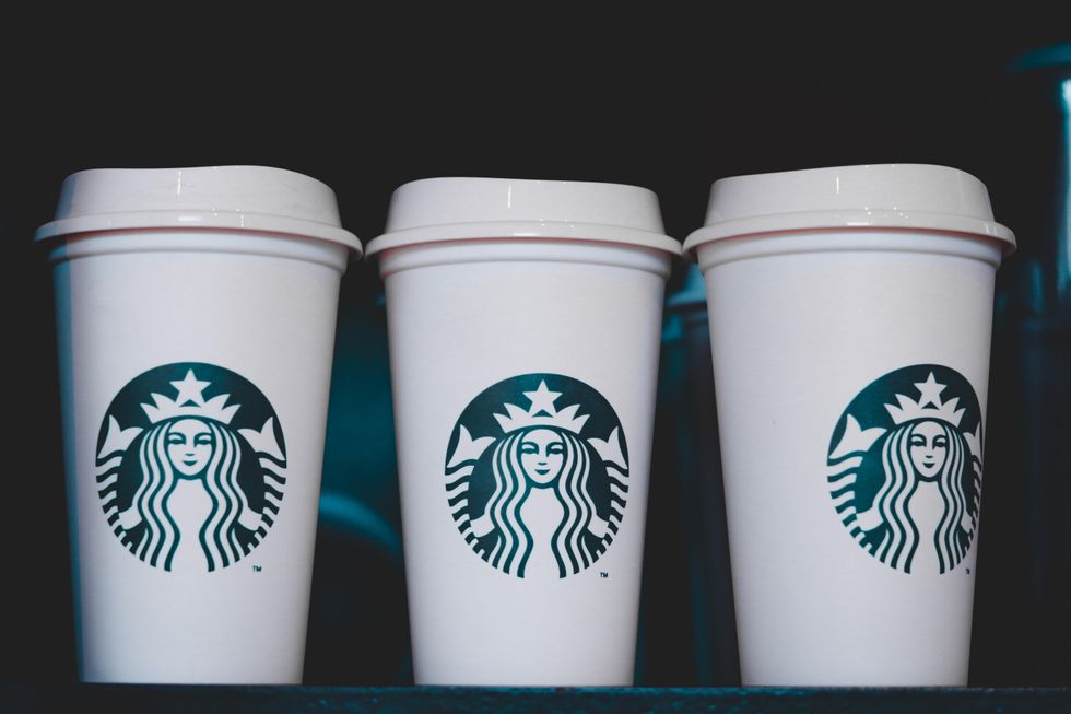 Three white Starbucks disposable cups