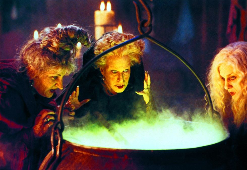 three witches from Hocus Pocus staring in to a cauldron