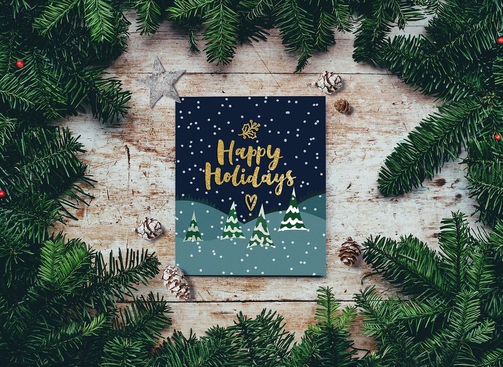 Tree branches, Card saying "Happy Holidays"