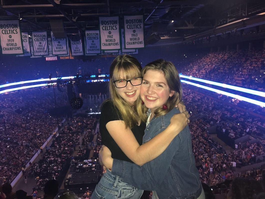 two best friends hugging at concert