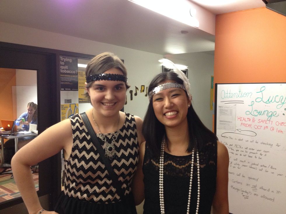 Two college students dress up for a 20s-themed dance.
