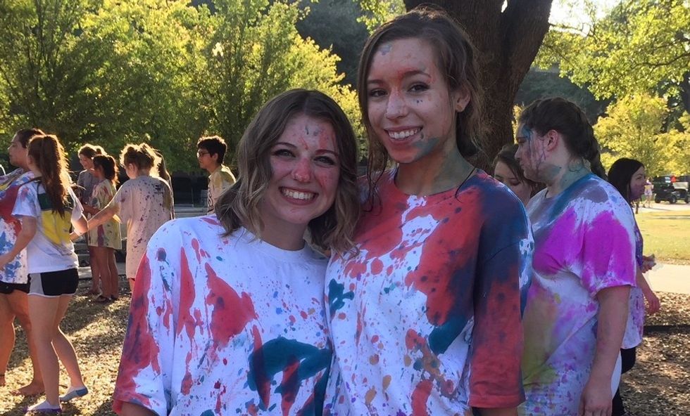 Two girls covered in paint