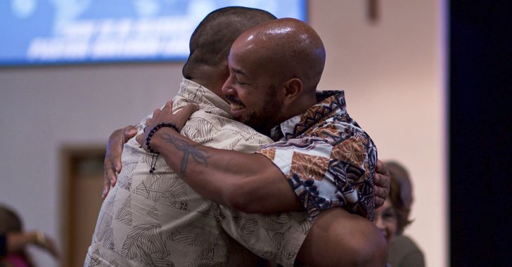 two men hugging tightly