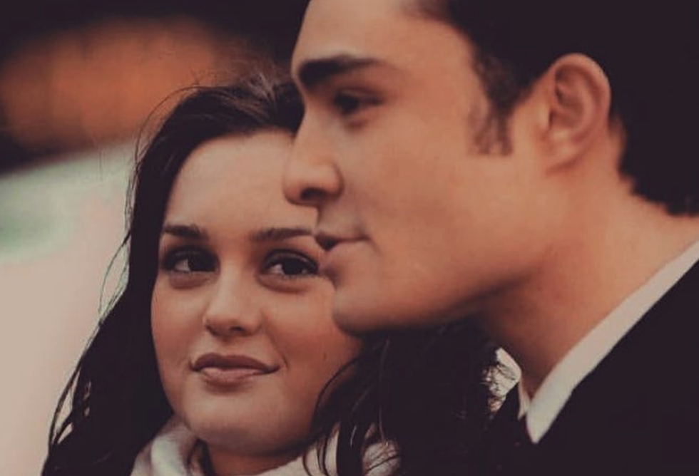 Two people covering their faces in a smoke filled room.