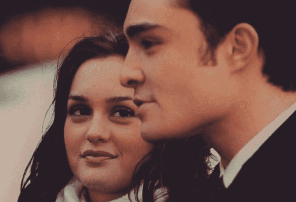 Two people covering their faces in a smoke filled room.