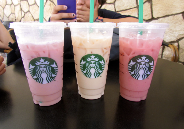Unknown Starbucks iced drinks in a row, left to right, pink drink, tan drink, hot pink drink.