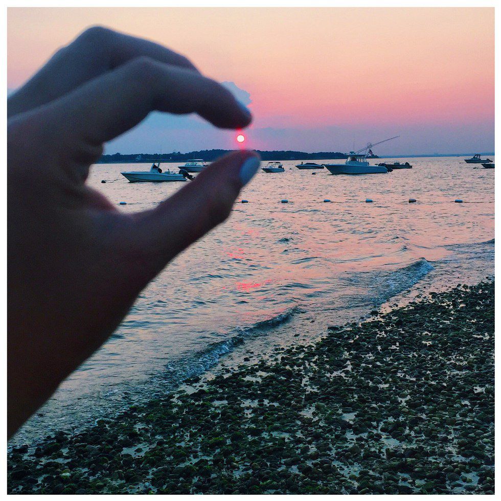 West Neck Beach incredible sunset framed by fingers in Long Island